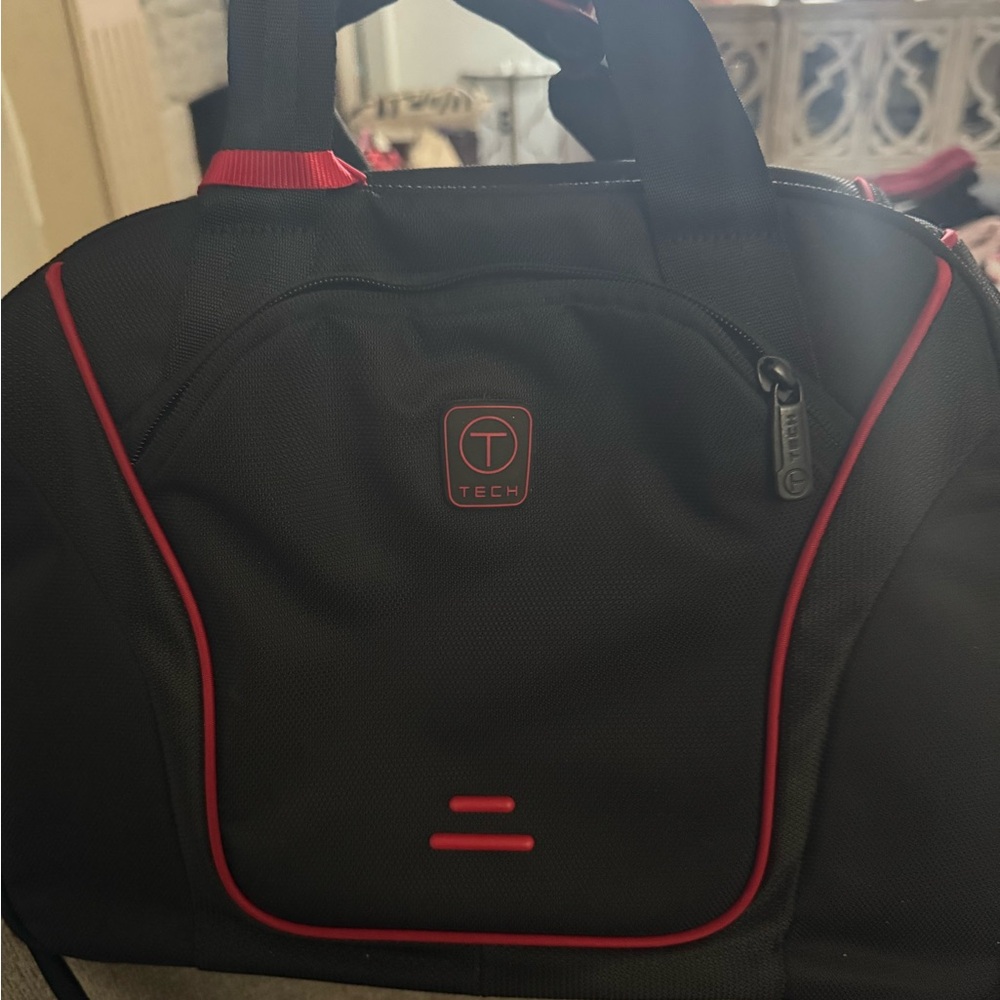 Tumi Black and Red Duffel Bag with Durable Fabric and Structured Design